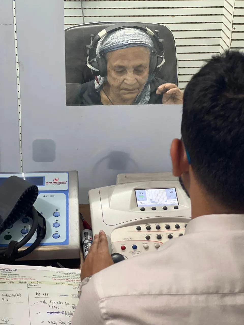 Audiologist providing patient care